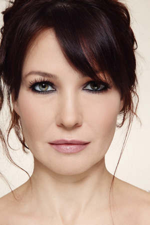 Close-up portrait of beautiful mature woman with smoky eyes and messy hairdoの写真素材