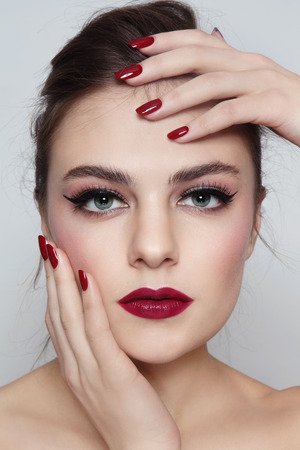 Portrait of young beautiful girl with red lips and manicureの写真素材