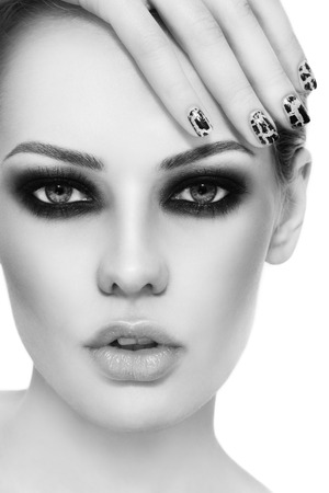Black and white close-up portrait of young beautiful woman with stylish make-up and crackle manicureの写真素材
