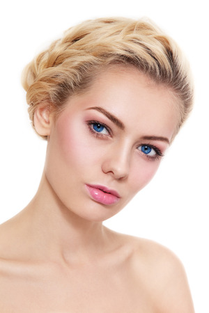 Portrait of young beautiful blond girl with braids and fresh pink make-up over white backgroundの写真素材