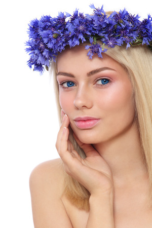 Young beautiful fresh girl with wreath of blue cornflowers on her head over white backgroundの写真素材