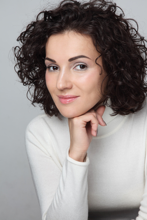 Young attractive woman with curly hair in casual outfitの写真素材