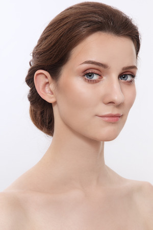 Portrait of young attractive woman with hair bun and clean make-upの写真素材