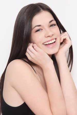 Young beautiful healthy laughing teen girl with long hairの写真素材