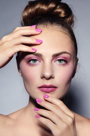 Portrait of young beautiful girl with stylifh hairdo, make-up and manicureの写真素材