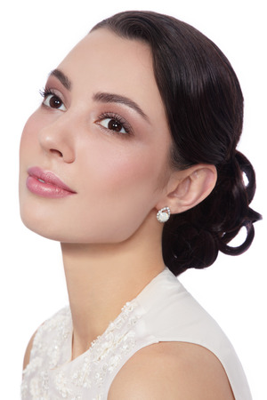 Young beautiful happy smiling bride with stylish make-up and hairdo over white backgroundの写真素材