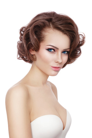 Young beautiful sexy woman with stylish curly hairdo over white backgroundの写真素材