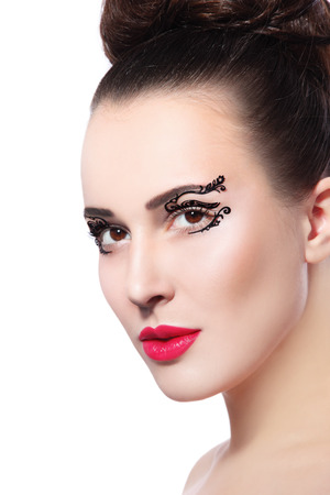 Portrait of young beautiful woman with fancy paper eye stickers and red lipstick over white background, copy spaceの写真素材