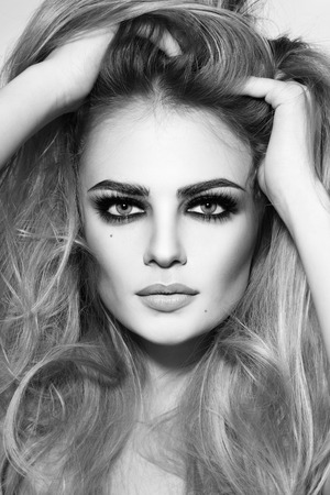 Black and white shot of young beautiful sexy girl with long hair and smoky eyesの写真素材