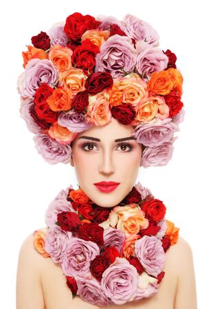Young beautiful woman in fancy wig of colorful roses over white backgroundの写真素材