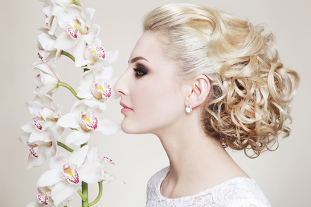 Profile portrait of young beautiful blonde bride with stylish prom hairdoの写真素材