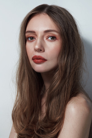 Young beautiful slim woman with messy hair and vintage style make-upの写真素材