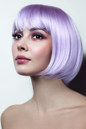 Young beautiful sexy girl with violet hair and fancy make-upの写真素材