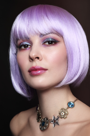 Young beautiful sexy girl with violet hair and fancy make-upの写真素材