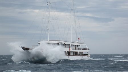 Tourist sailboat sailing on waves through the storm in summer from Croatiaの写真素材
