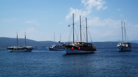 Four anchored touristic, sailing cruise ships at bay near island Krk                             