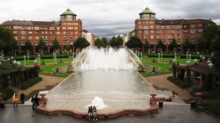 Mannheim,Germany - August 27, 2010: People relaxing near the Fountain at cloudy dayのeditorial素材