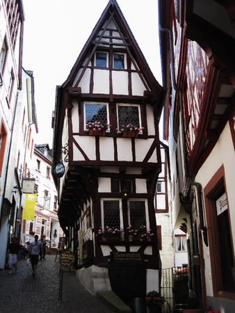 Bernkastel,Germany - 1 July, 2010: People are walking around the traditional old wooden house on street in Germanyのeditorial素材