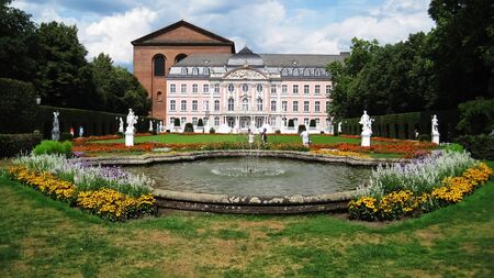 Merzig,Germany - 1 August,2010: People walking and taking photos at pink,baroc electional palace behind fountain in summer in Germany at sunny hot dayのeditorial素材