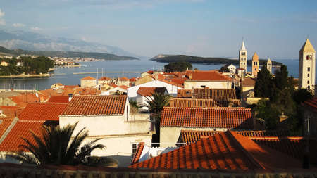 Landscape and four catholic churches in a row on the island of Rab in summerの写真素材