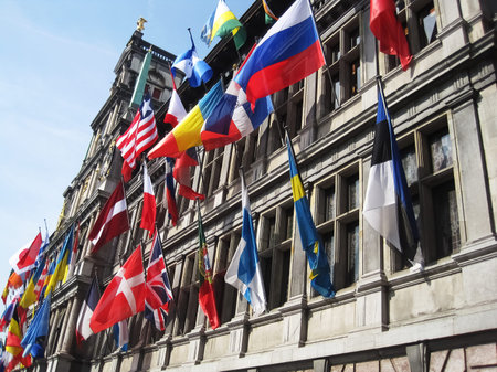 Multinacional,colorful flags on the town hall of Antwerp