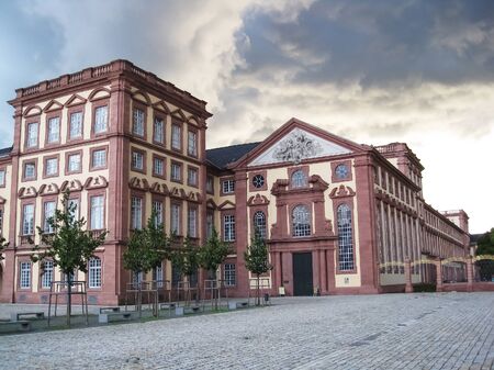 Alley leading to the entrance of the Mannheim University at cloudy day, and storm is closing in|pink|red|baroqueのeditorial素材