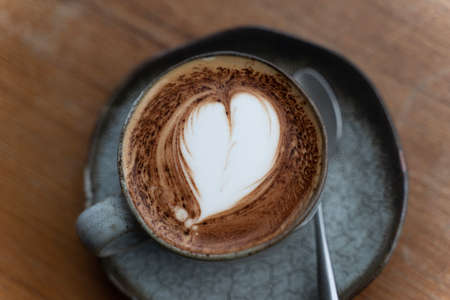 A cup of coffee with latte art top viewの写真素材