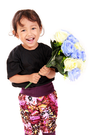 Sweet little girl with cute smile holding a bouquet of roses, isolated on white backgroundの写真素材