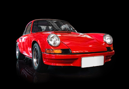Red classic sports car isolated on black background Red classic sports car isolated on black background