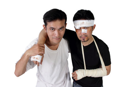 A guy helps an injured man walking towards camera, isolated on white backgroundの写真素材