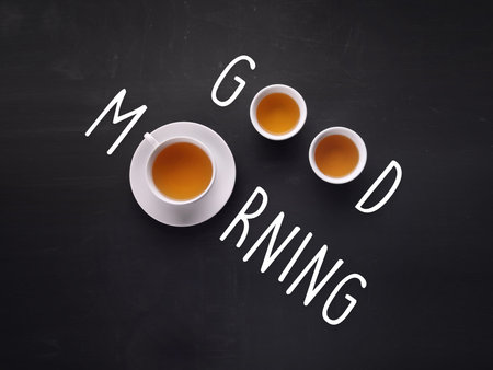 Good Morning. Tea cups composed with written text on blackboardの写真素材