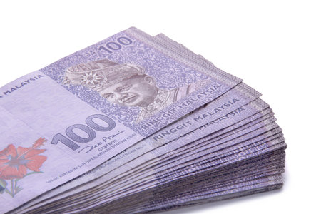 Malaysian Ringgit money in hundred nominal, stacked on white background