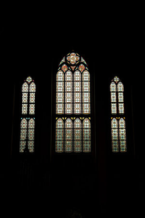 Decorative neo-gothic style glass window inside an old church