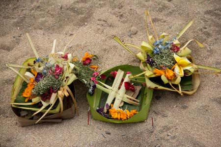 Spiritual Hindu offerings laid on a beach in Bali, Indonesiaの写真素材