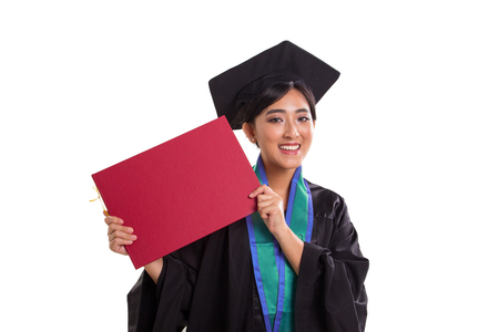 Young Asian female bachelor proudly showing her graduation certificate to camera, close up, studio shotの写真素材