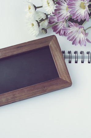 Black borad with Flowers on notebook vintage toneの写真素材