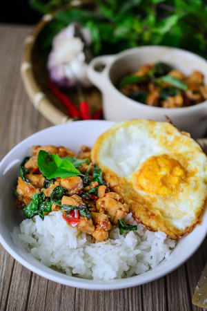 Stir Fried Basil Cicken with Rice and Egg on wooden, Thai Famous Food, Thai Street Food, Thai Cuisine, Thai Spicy Foodの写真素材
