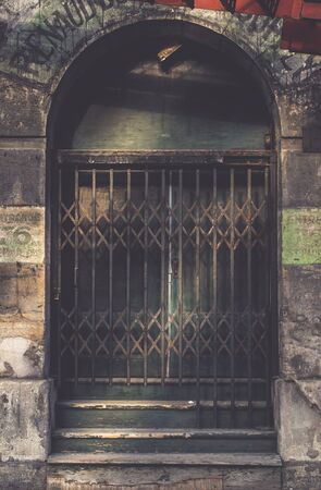 vintage sliding barred door in the dark tone  for interior or exterior brick wall building decoration texture backgroundの写真素材