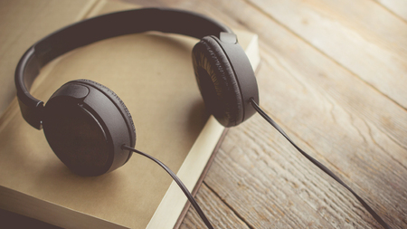 Morning relaxation and cozy with red heart and small flowers on the book with copy space on wooden background  for nostalgic,  lifestyle , music therapy conceptの写真素材
