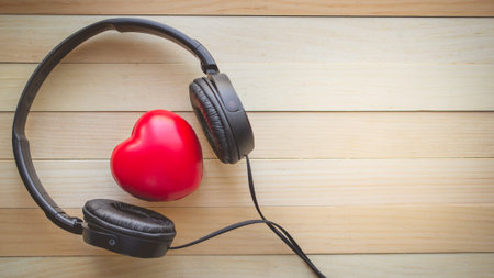 Relaxation and cozy with Heart listen music on wooden background and copy space for love and music conceptの写真素材