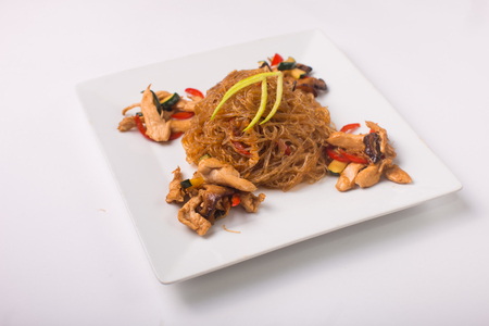 Funchoza noodles with chicken on a white backgroundの写真素材
