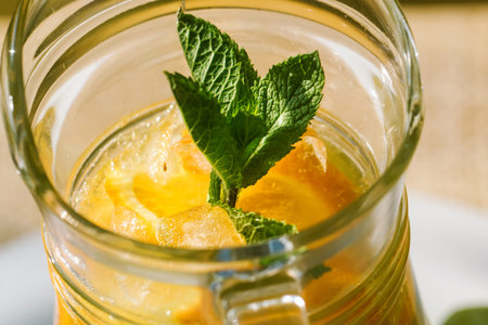 Cool refreshing drink on the background of nature and green treesの写真素材