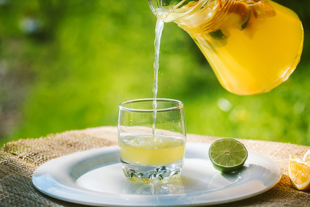 Cool refreshing drink on the background of nature and green treesの写真素材