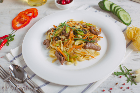 Spaghetti with Vegetables, Ham, Black Olives, Rucola and Pesto Sauceの写真素材