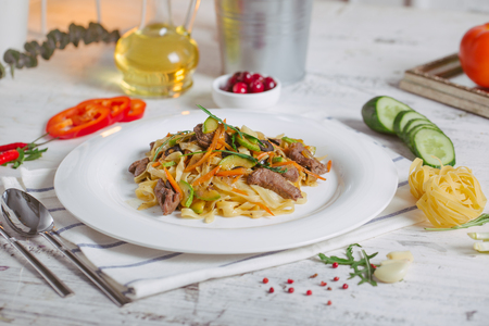 Spaghetti with Vegetables, Ham, Black Olives, Rucola and Pesto Sauceの写真素材