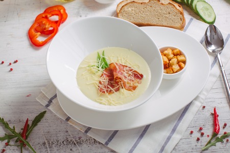 Cheese soup with roast bacon, herbs and spicesの写真素材