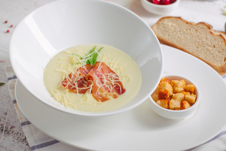 Cheese soup with roast bacon, herbs and spicesの写真素材
