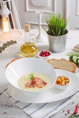 Cheese soup with roast bacon, herbs and spicesの写真素材