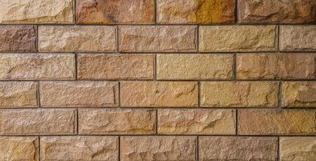Brown and orange brick wall art concrete or stone texture backgroundの写真素材