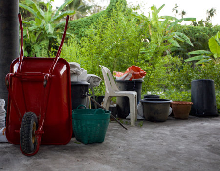 red wheelbarrow or trolley and equipment  for gardening in home near garden